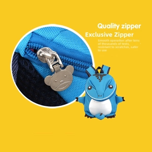 Quality bear-shaped metal zipper detail on a blue dinosaur backpack for kids