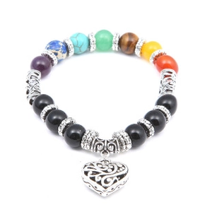 Detail of bohemian seven chakra solar system bracelet with hollow heart charm