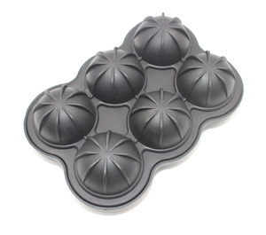 Detail of a black silicone ice ball mold with six spherical slots on white background