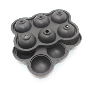 Detail of 6-hole black silicone ice ball mold with top fill holes and split design