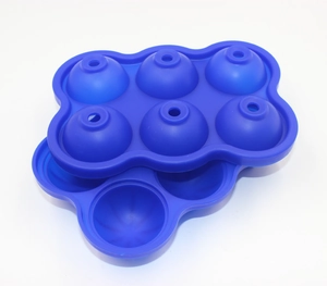 Blue food-grade silicone mold for making six large round ice spheres on white background