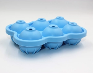 Close-up of a blue 6-hole silicone ice sphere mold for round ice cubes on white background