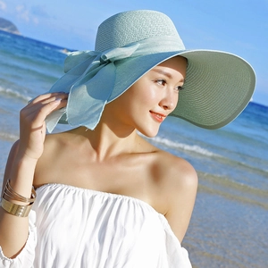 Mint green wide brim straw beach hat with a decorative bow for summer sun protection