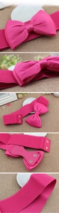 Detail showing rose pink elastic waist belt with large satin bow and metal snap buttons