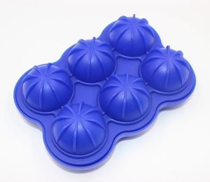 Detail of blue silicone ice mold featuring six textured hemispherical cavities for round ice