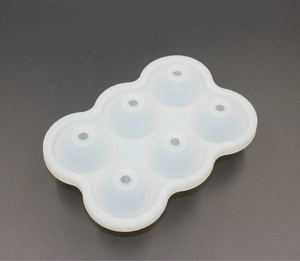 Top view of a white semi-transparent silicone 6-hole round ice ball mold with water inlets