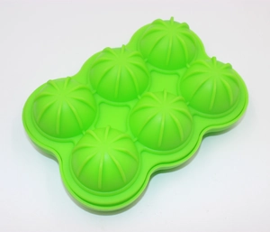 Detail of green 6-cavity silicone mold with hemispherical ribbed grooves for ice making