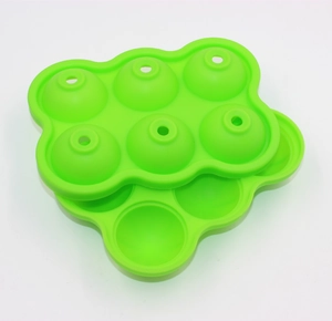Close-up of green 6-hole food grade silicone ice ball mold for spherical ice cubes