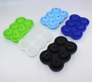 Set of 5 colorful 6-cavity round silicone ice ball molds on white background