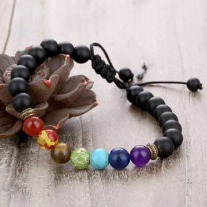 Close-up of adjustable chakra bead bracelet featuring seven stones on a lotus stand