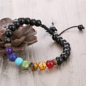 Macro shot of 7 Chakra healing energy beaded bracelet with adjustable woven cord