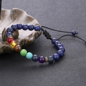 Detailed macro view of adjustable chakra beaded bracelet with natural stones and woven cord
