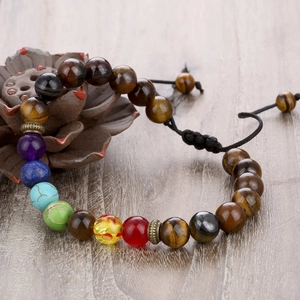 Macro detail of Seven Chakra beads on a tiger eye stone bracelet with adjustable cord