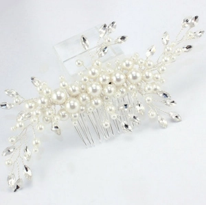 Detailed macro of handmade bridal hair comb with pearls, crystals, and silver wiring