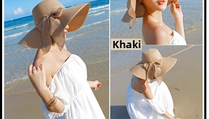 Detalle del gran sombrero de paja caqui con un elegante lazo ideal para playa y sol