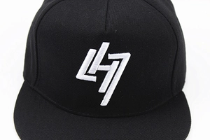 Close-up of premium cotton twill fabric and white 3D embroidery on black baseball cap