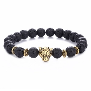 Black lava stone bracelet with golden leopard head and patterned beads on white background