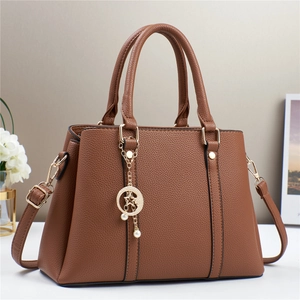 Brown lychee leather tote bag with star moon charm and adjustable strap for women