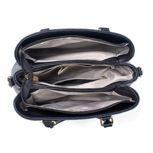Detail view of large capacity tote bag featuring three zipped compartments and gray lining
