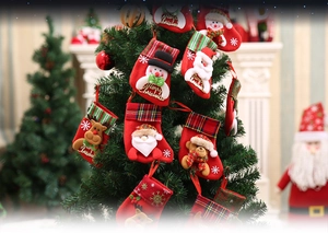 Detail of Christmas stockings with Santa, Snowman, Reindeer and Bear on a tree