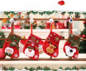 Detail of hanging Christmas stockings set featuring Santa, Reindeer, Snowman, and Bear