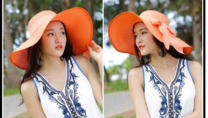 Detalle de sombrero de paja coral con ala ancha y lazo decorativo para mujer