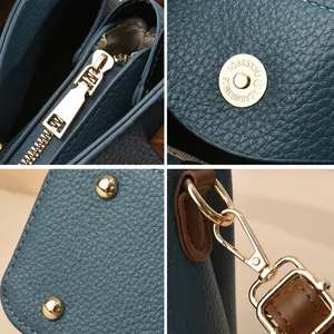 Dettaglio della borsa blu in pelle a grana con eleganti finiture metalliche in oro lucido