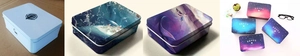 Detail view of rectangular tin coin purses with cartoon art prints and secure metal lids