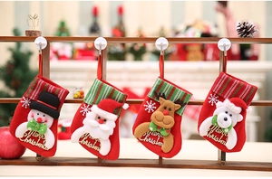 Set of four red felt Christmas stockings with 3D Santa, deer, and snowman characters