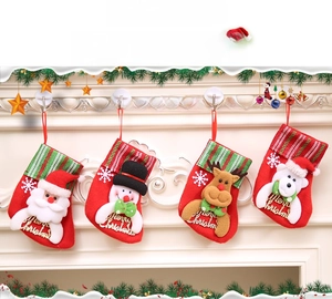 Close-up of four Christmas stockings featuring Santa, Snowman, Reindeer, and Bear on a fireplace