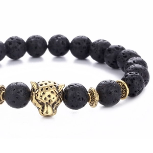 Lava stone bead bracelet featuring a golden leopard head charm on a white background