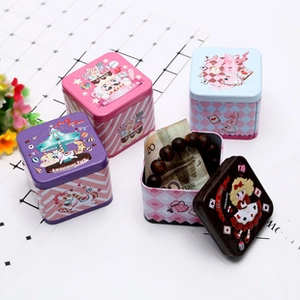 Detail view of square tinplate coin purses featuring cartoon prints and inner storage