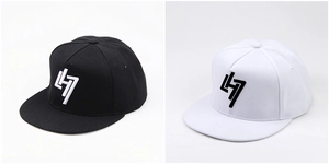 Detail view of black and white snapback hats with 3D embroidered geometric logo