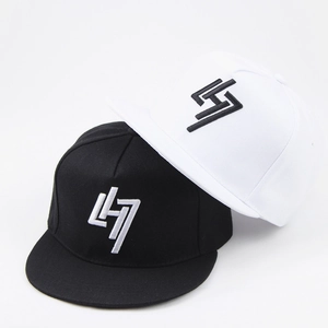 Detail of black and white flat brim baseball caps featuring 3D embroidered logo