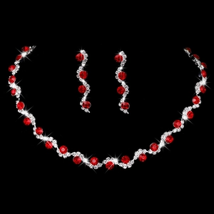 Silver-plated bridal jewelry set with red gemstones and crystals on black background
