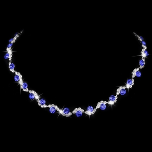 Close-up of wavy silver necklace with blue circular gemstones and sparkling rhinestones