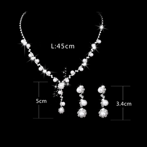 Bridal jewelry set with sunflower rhinestone pearl necklace and long earrings on black background