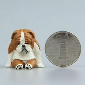 Detailed view of small resin bulldog figurine with a coin showing the compact product size