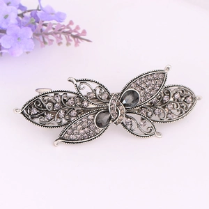 Macro view of vintage butterfly hair clip with grey crystals and silver filigree detail