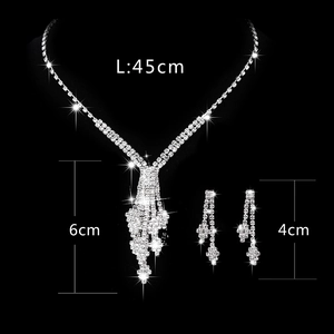Sparkling silver rhinestone jewelry set with tassel necklace and earrings on black background