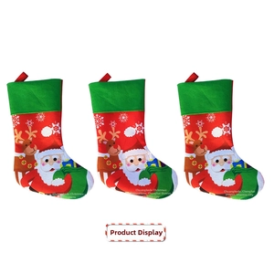 Detailed view of red and green felt Christmas stockings with Santa and reindeer motifs