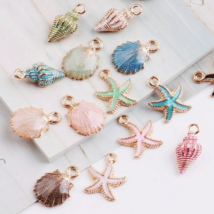 Flat lay of colorful enamel sea shell and starfish alloy charms for DIY jewelry making