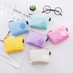 Flat lay of colorful canvas coin purses in macaron tones with metal zipper closure