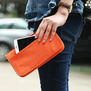 Orange fabric travel wallet and smartphone pouch with convenient external pocket