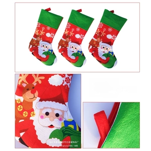 Detailed view of three felt Christmas stockings featuring Santa, elk, and snowflake patterns