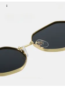 Detail of adjustable silicone nose pads and gold metal frame of polygon sunglasses