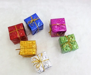 Macro detail of laser foam gift boxes with golden ribbons on white faux fur background
