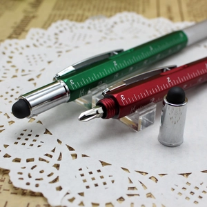 Detailed macro view of multi-functional metal pens with ruler scale and screwdriver tip