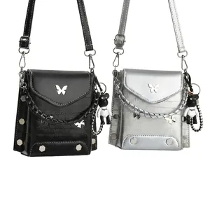 Detail of hardware butterfly clasp and litchi grain leather on mini shoulder bags