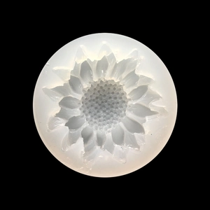 Top view of a translucent daisy silicone mold for DIY flower resin art on black background
